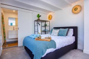 a bedroom with a bed with a tray on it at Coast Guesthouse in Zandvoort