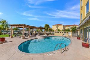a swimming pool in a courtyard with a patio at Sleep Inn & Suites Midland West in Midland