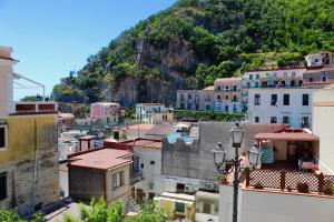 a view of a city with a mountain in the background at Cetara Costa d'Amalfi Residence in Cetara