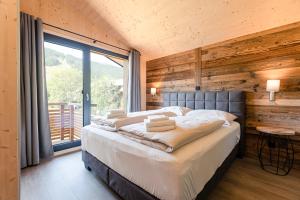 Кровать или кровати в номере Kreischberg Suites by ALPS RESORTS