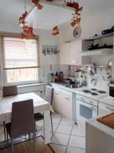 a kitchen with white cabinets and a table and a sink at Steinatal in Bad Sachsa