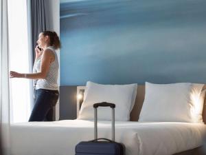 Ein Bett oder Betten in einem Zimmer der Unterkunft Novotel Charleroi Centre