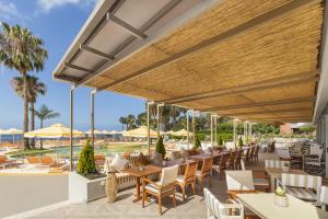 a patio area with chairs, tables and umbrellas at NEXT - by Savoy Signature in Funchal