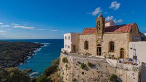 an old church on a cliff next to the ocean at Nireides villas 'TOP DESTINATION' in Elafonisi