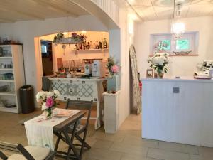 a kitchen with a table and a counter with flowers on it at Bed and Breakfast 57 in Asuel
