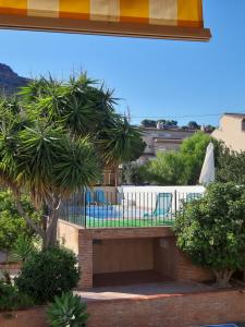 a balcony with a table and chairs and trees at Moya, relax en la Calderona in Gilet