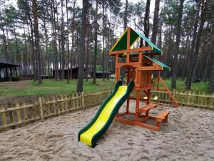 a playground with a slide in the sand at Leśniczówka-Wdzydze Pe eL in Wdzydze Kiszewskie