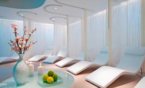 a living room with a vase and a table with fruit at Porto Platanias Beach Resort & Spa in Plataniás