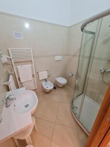 a bathroom with a shower and a sink and a toilet at Il Vascello in Porto Cesareo +45 photos