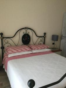 a bedroom with a large bed with a black headboard at 6alcentrale in Bellagio