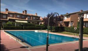 a swimming pool in front of some houses at CHALET HARO (LA RIOJA) in Haro