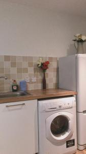 a kitchen with a white refrigerator and a dishwasher at Heart Of Aberdeen City Centre 3 Bedrooms Apartment in Aberdeen