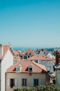 a view of a city with roofs at Hotel Saint Julien in Biarritz