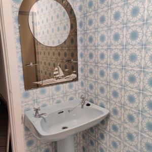 a bathroom with a sink and a mirror at Crow's Nest Glandore - 4 - Self Catering in Glandore
