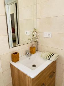 a bathroom with a sink and a mirror at Clemens9 Premium in Málaga +86 photos