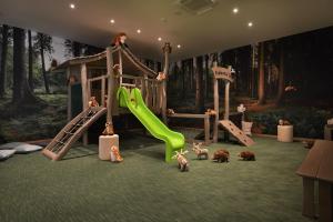 a play room with a slide and play equipment at Hotel Element in Lipno nad Vltavou