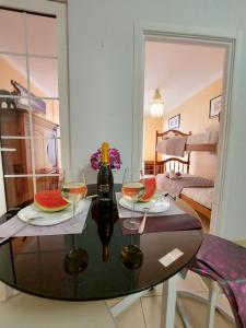 a table with two glasses of wine and a bottle at Adeje House 2 bedrooms, Wifi Free in Adeje