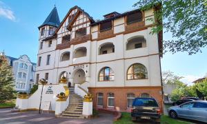 a large building with a staircase in front of it at Meduza Natura Tour in Świnoujście