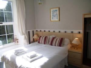 a bedroom with a bed with two towels on it at The George Borrow Hotel in Ponterwyd