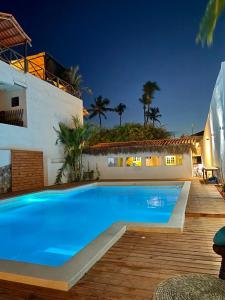 a large blue swimming pool next to a house at Pousada Duna Beach in Jericoacoara