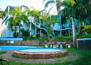 a resort with a swimming pool and a building at Margate Hotel in Margate