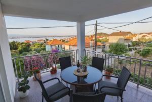 einen Balkon mit einem Tisch und Stühlen sowie Aussicht in der Unterkunft Apartman Sara in Preko