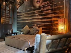 a bedroom with a bed and a wall with a painting at Private Room & Spa avec jacuzzi privatif in Lille
