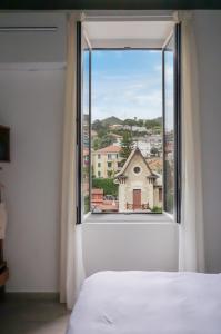 a bedroom with a window with a view at Il Caruggio Home in Varazze +51 photos