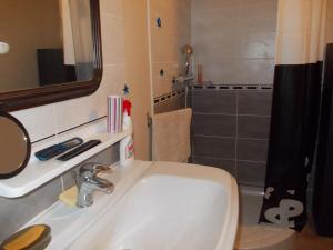 a bathroom with a white sink and a shower at La Bergerie in Sost +27 photos