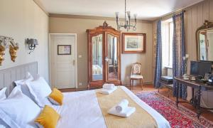 a bedroom with a large white bed with yellow pillows at Domaine Utah Beach - Le Grand Hard in Sainte-Marie-du-Mont
