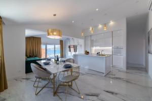 a kitchen and living room with a table and chairs at Besker Apartment in Trogir