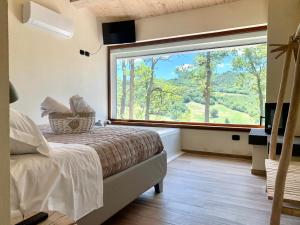 Postel nebo postele na pokoji v ubytování Agriturismo Il Cornio