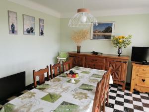 a dining room with a table with a table cloth at Gite CLEVACANCES in Laval-du-Tarn