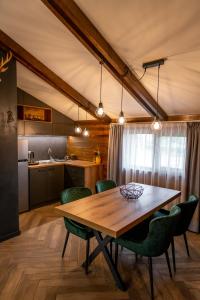 a kitchen and dining room with a wooden table and chairs at Hotel Hunters House in Ezerets