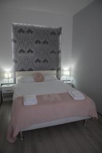 a bedroom with a bed with two towels on it at DIS apartman 1 in Kruševac