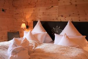 ein Schlafzimmer mit einem Bett mit weißen Kissen in der Unterkunft Alpensuite Wellness in Inzell