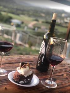 uma mesa com um prato de comida e uma garrafa de vinho em Chalet Nativo - Fabulous Terrace & Vineyard em Valle de Guadalupe