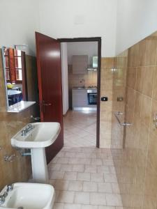 a bathroom with a sink and a toilet and a shower at Verde & Mare in Palmi +107 photos