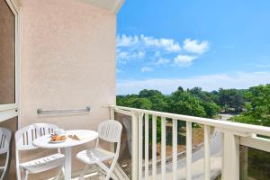 a balcony with a table and chairs and a view at Hotel Istra Plava Laguna in Poreč