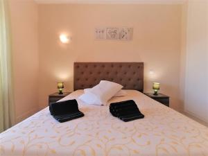a bedroom with a bed with two black bags on it at Summer Beach Apartment litoralmar in Portimão +23 photos