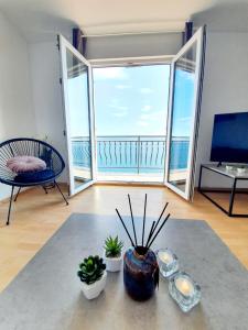 a living room with a large window with a view of the ocean at Apartment ZaDoDa in Omiš +89 photos