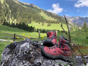 a pair of hiking boots sitting on top of a rock at Haus Sonnenterrasse in Fiss