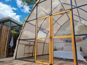 a glass dome house with a mattress inside at Ecoglamping Reserva Natural Paraíso Andino in La Vega