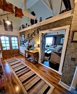 a living room with a door open to a bedroom at Salmon Landings in Strathy Point