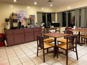 a restaurant with tables and chairs and a kitchen at Knights Inn & Suites Dublin in Dublin