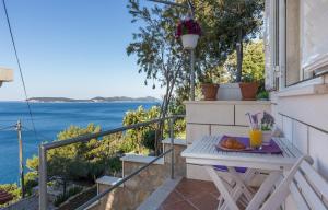 una mesa en un balcón con vistas al agua en Apartments Lovro, en Dubrovnik