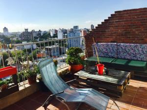 a balcony with a table and chairs on a roof at Penthouse Malva Rosa in Montevideo