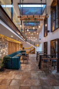 a restaurant with tables and chairs and a staircase at NISSEA Boutique Hotel in Kardamaina