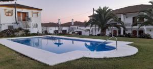 a swimming pool in front of a house at El Almendral in El Bosque