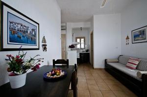 a living room with a table and a couch at Violetta Apartments in Neo Klima